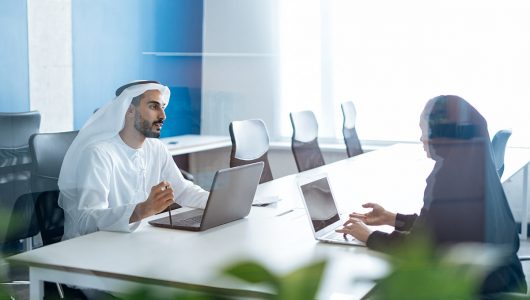 man-woman-with-traditional-clothes-working-business-office-dubai